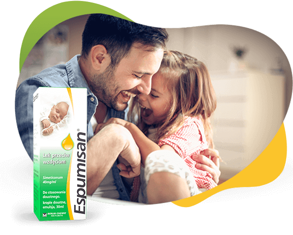 Radosny ojciec przytula córkę śmiejącą się po zażyciu Espumisan® krople 40 mg, przed nimi opakowanie.